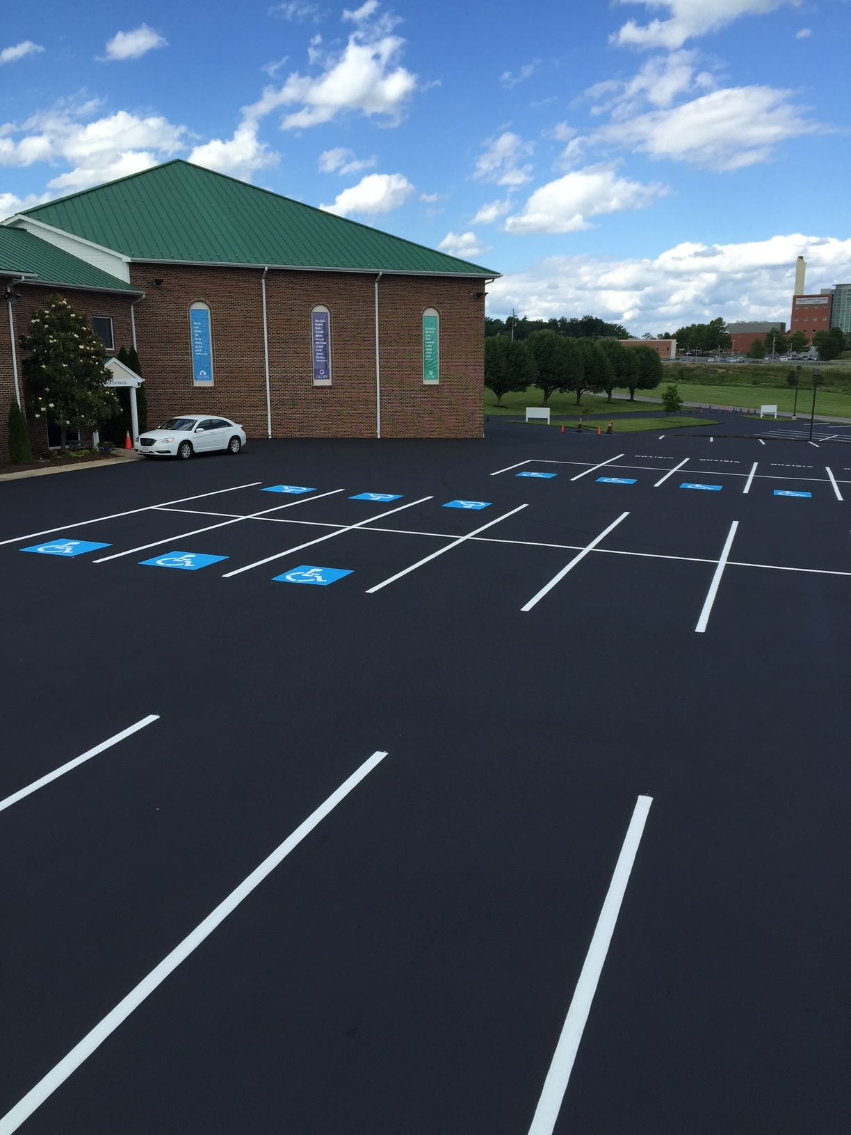 parking lot with a brick building in the background
