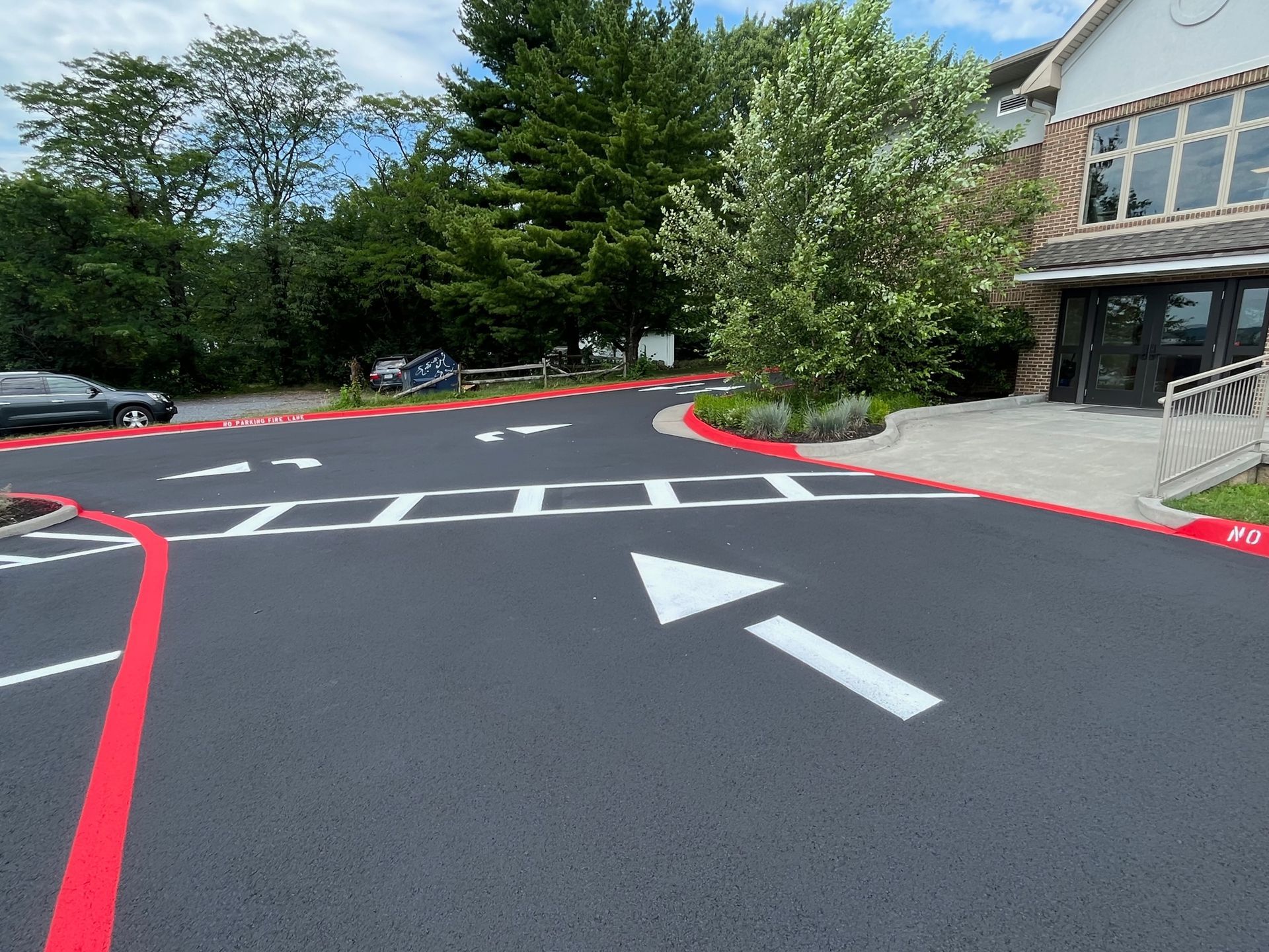 a parking lot with a white arrow pointing to the right
