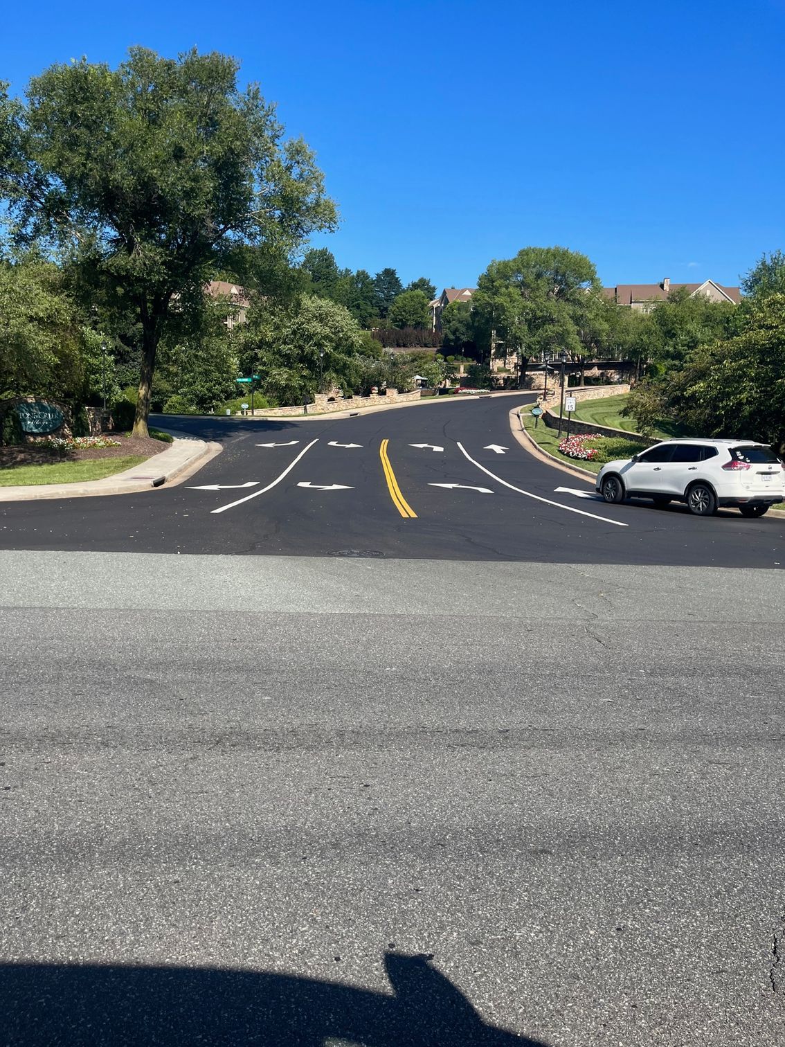 a white SUV is parked on the side of the road at an intersection