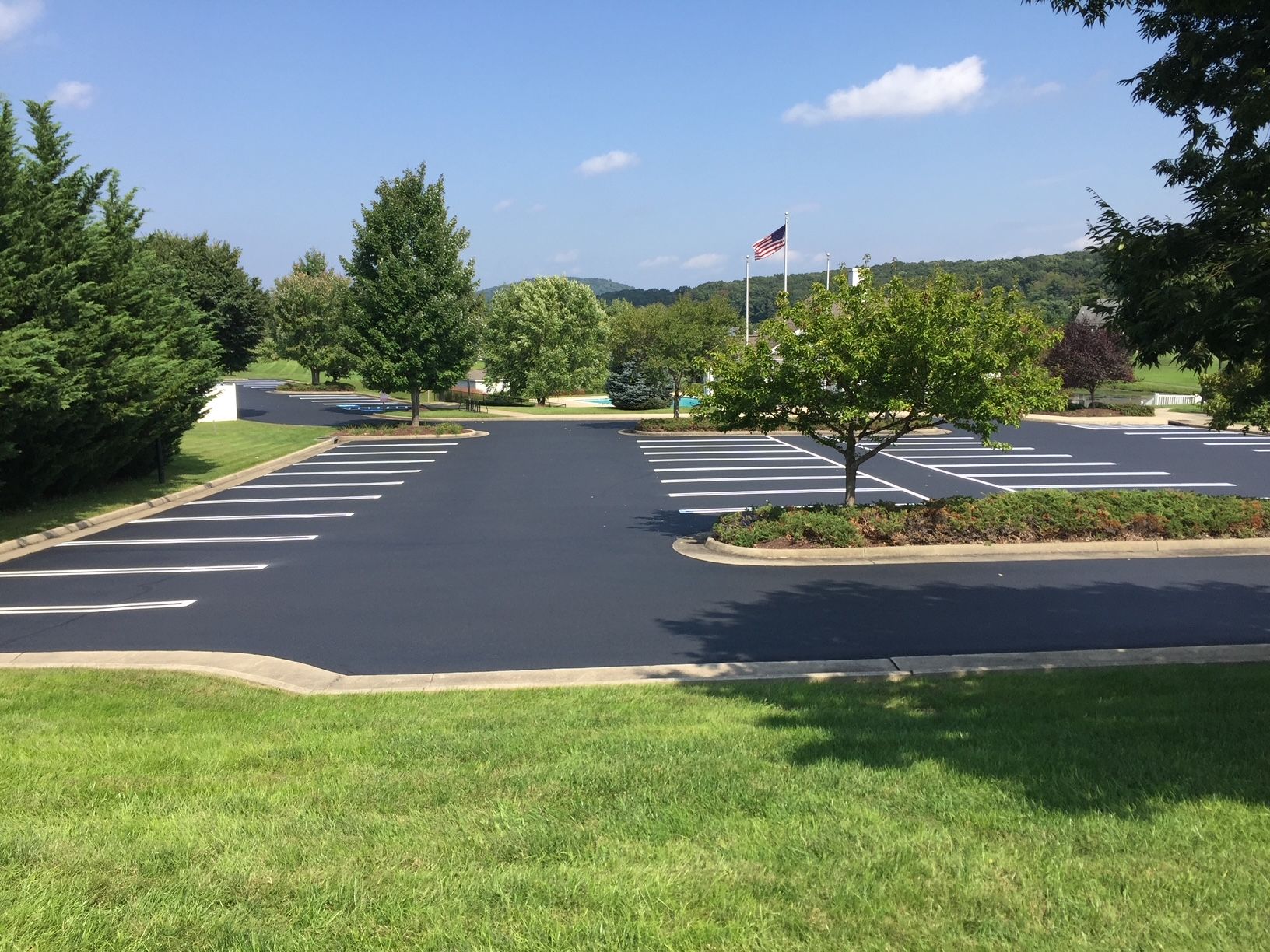 a parking lot with a flag in the background