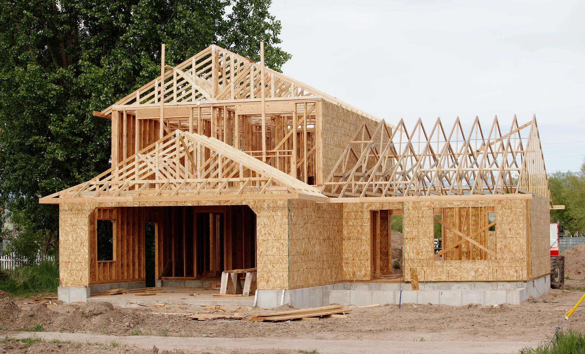 Framed wooden house under construction.