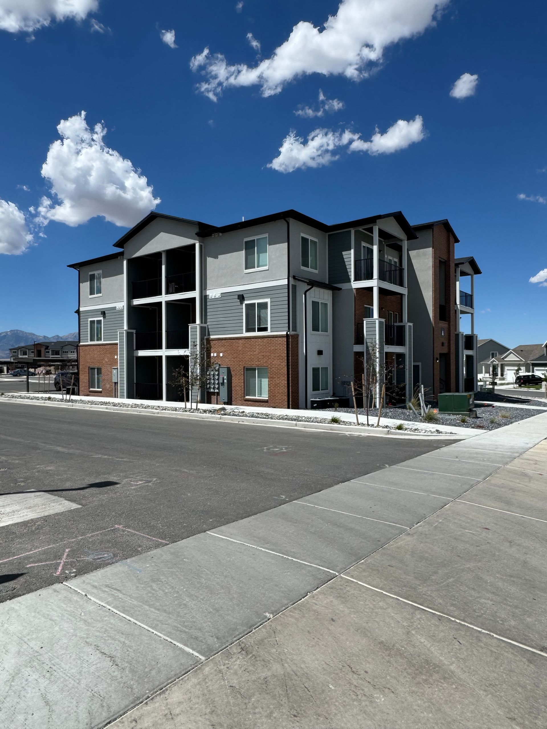 A large apartment building with a blue sky in the background
