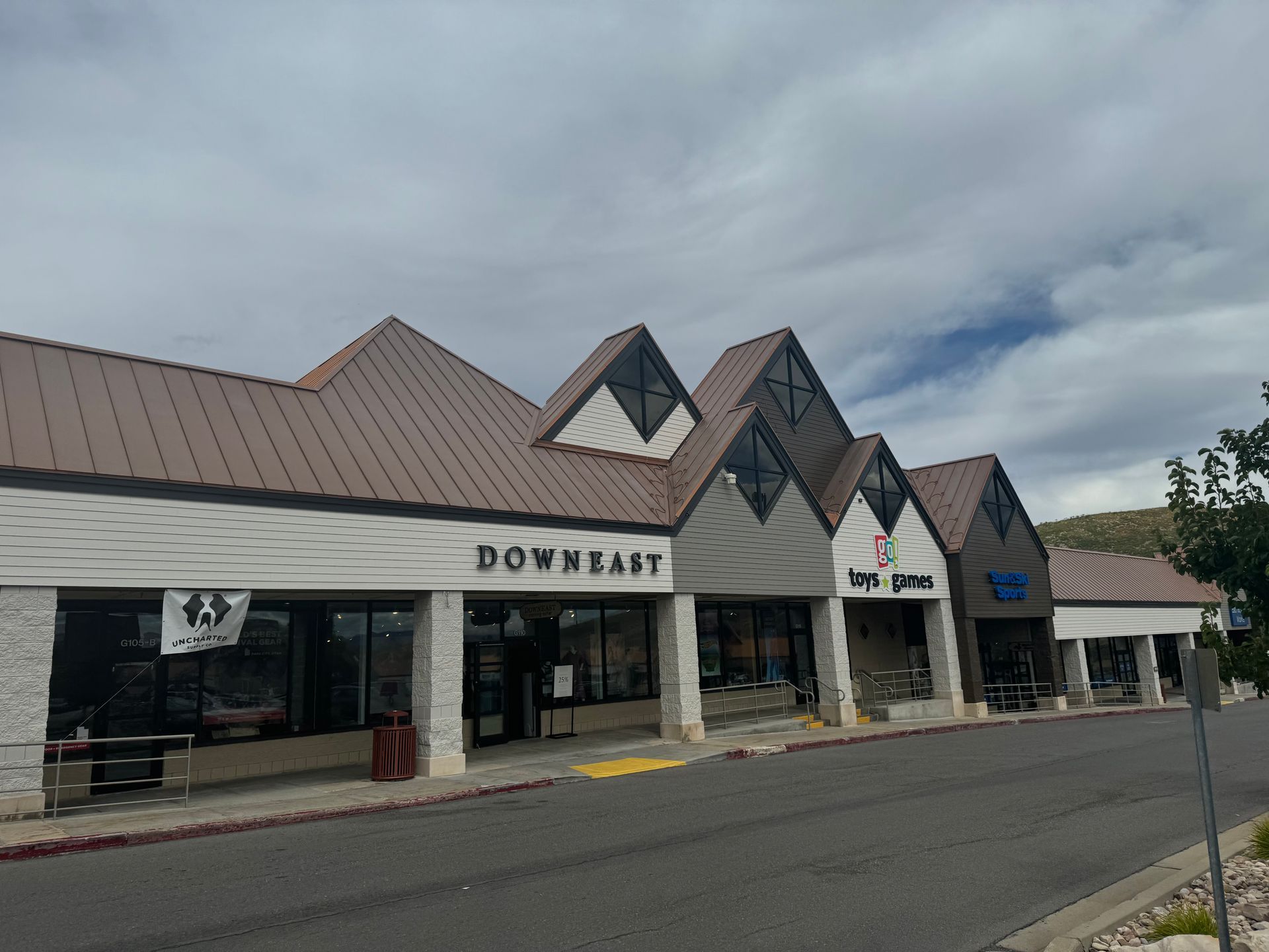 A building with a brown roof and the word downeast on it