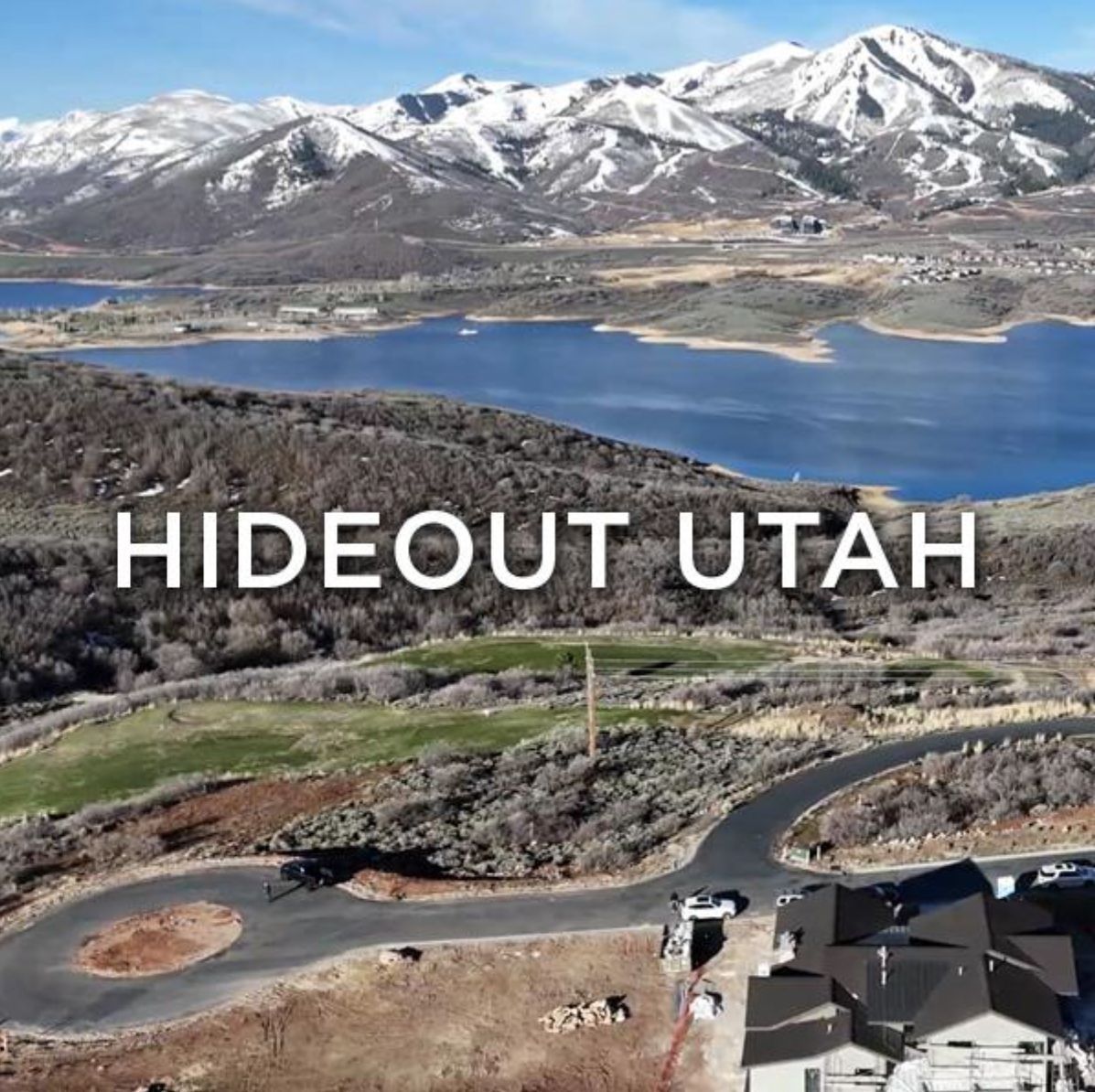 An aerial view of hideout utah with mountains in the background