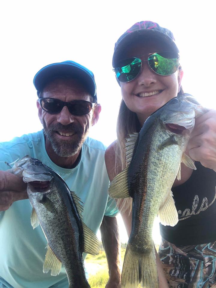 Happy people holding fish