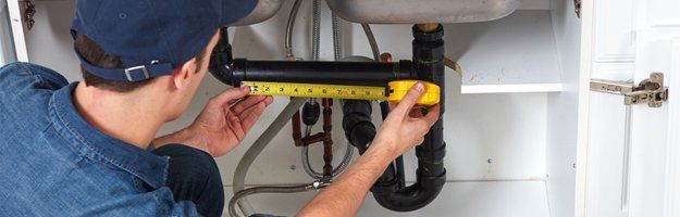plumber measuring pipe