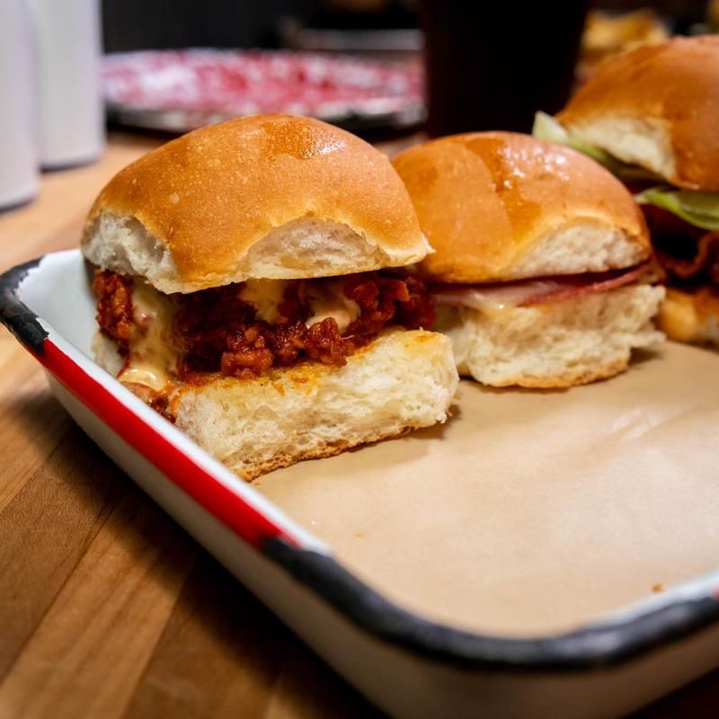 A bunch of sandwiches on a tray on a table