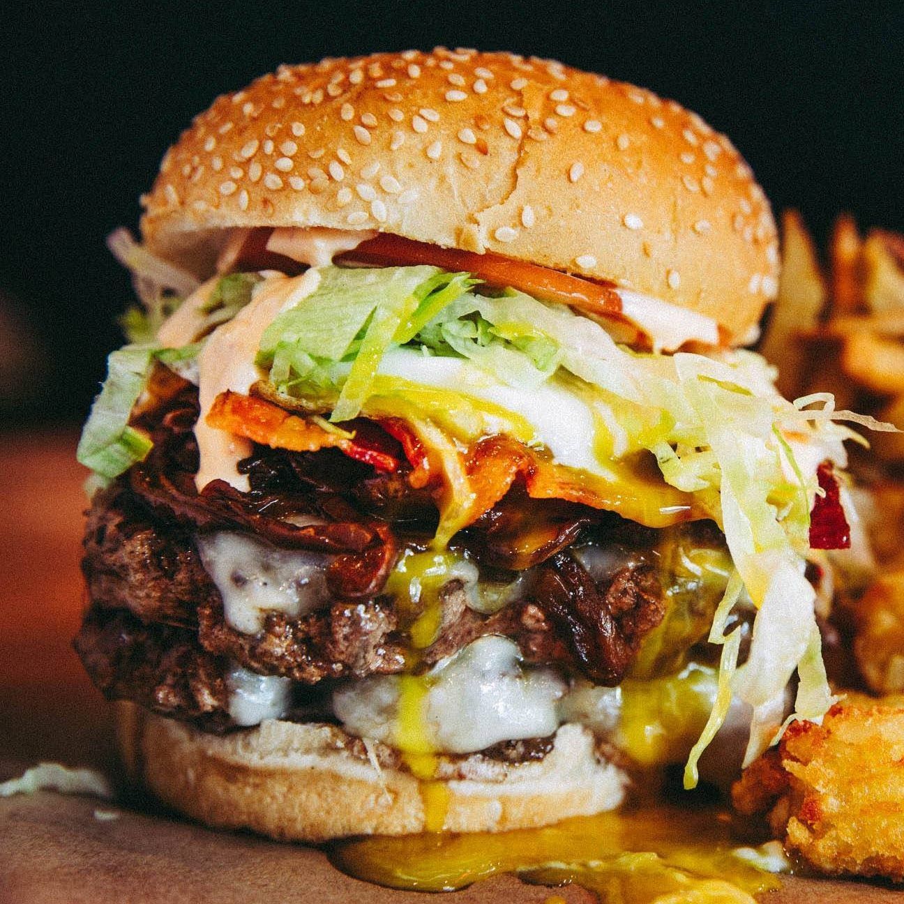 A close up of a hamburger and french fries on a table