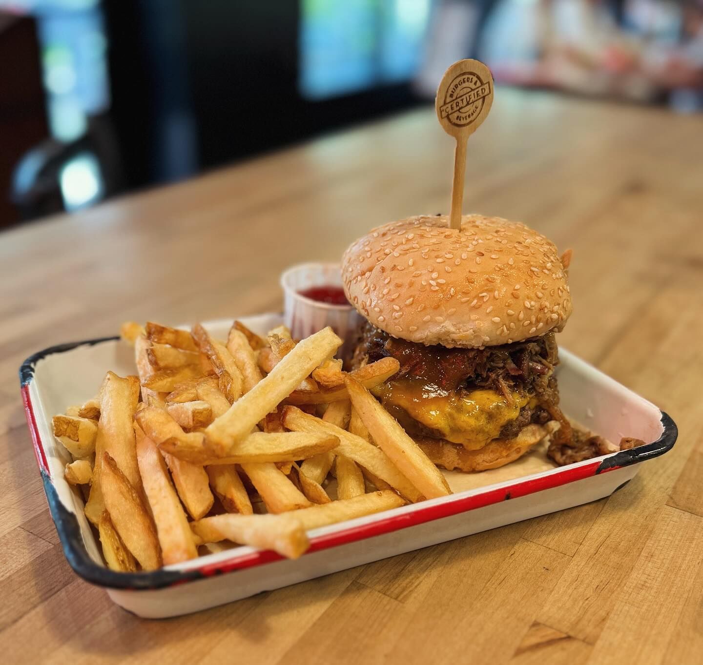 A hamburger and french fries on a tray on a table