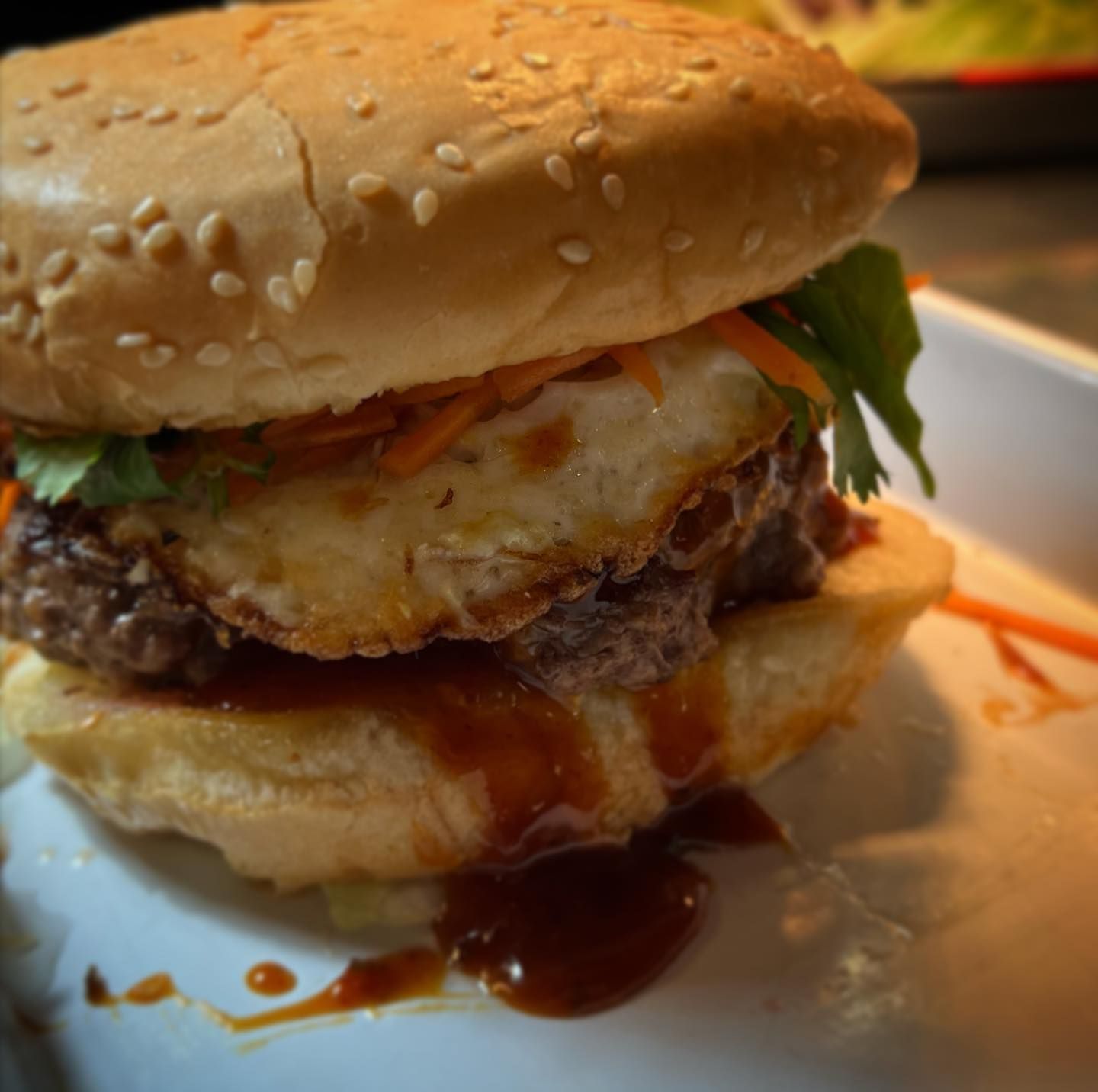 A close up of a hamburger on a white plate