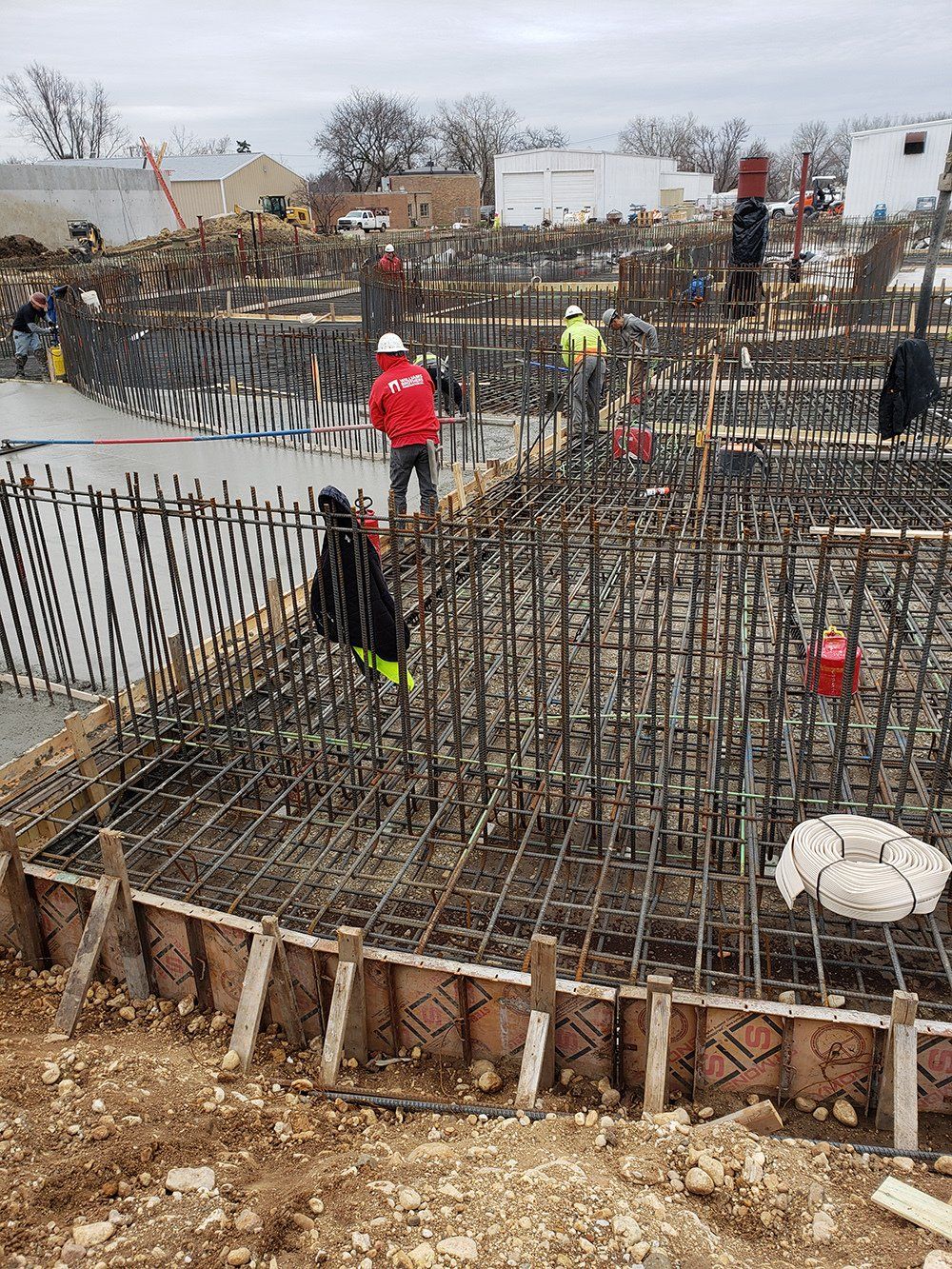a group of construction workers are working on the floor of a building
