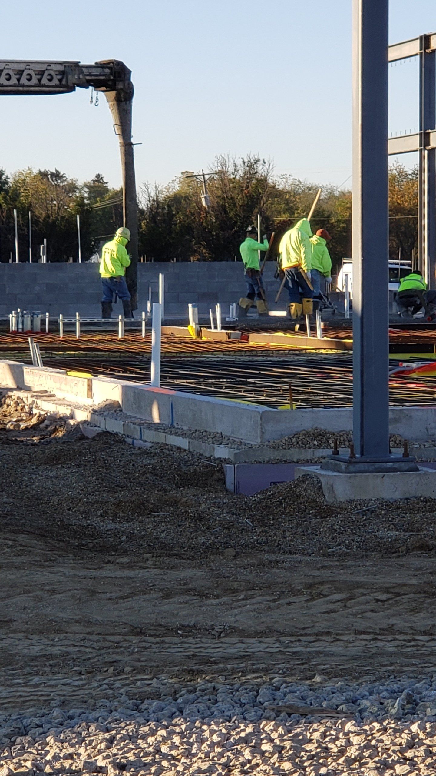 workers are laying the foundation on the construction site