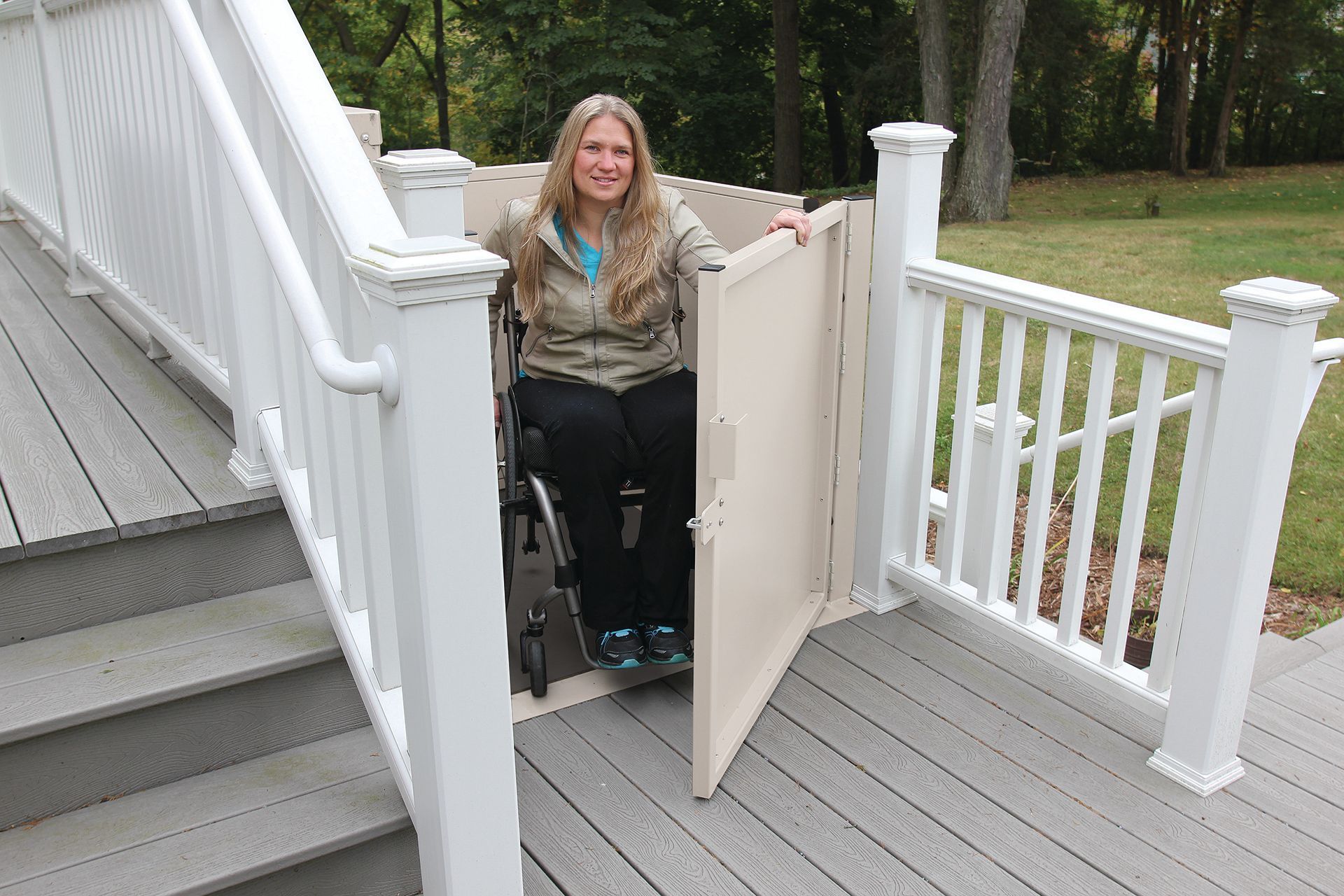 A woman in a wheelchair is going up a set of stairs.
