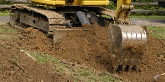 Excavator removing soil