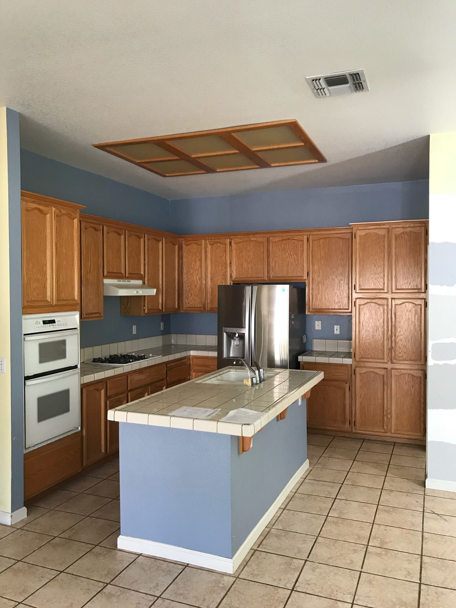 A kitchen with stainless steel appliances and wooden cabinets