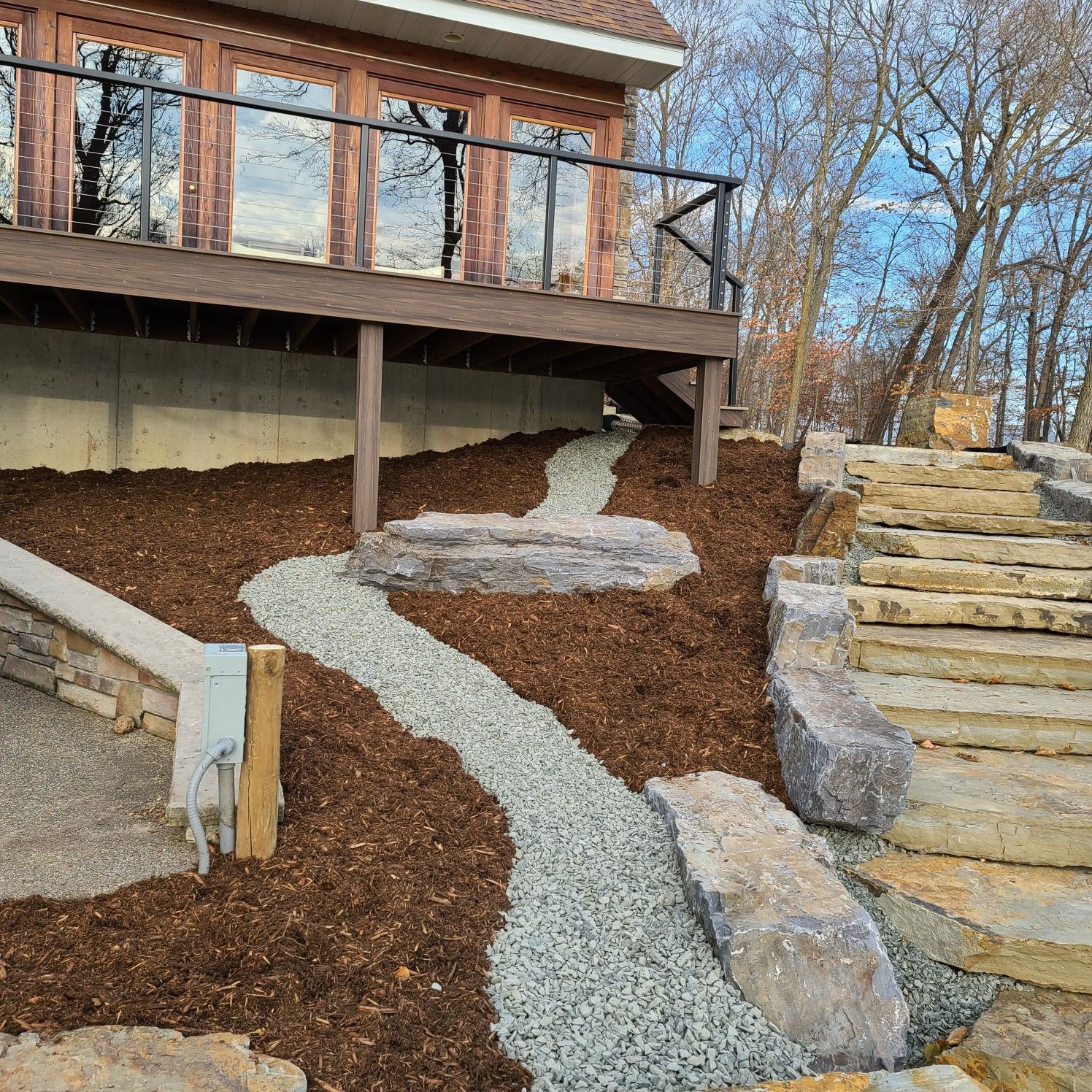 A house with a walkway leading to it and stairs leading up to it