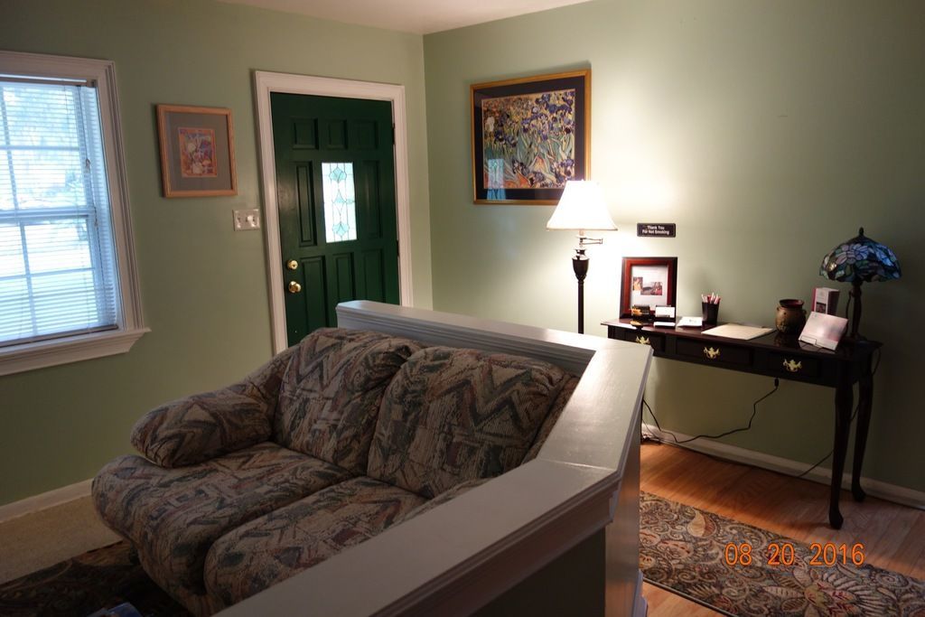 A living room with a couch and a desk