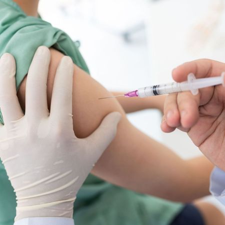 A person is getting an injection in their arm