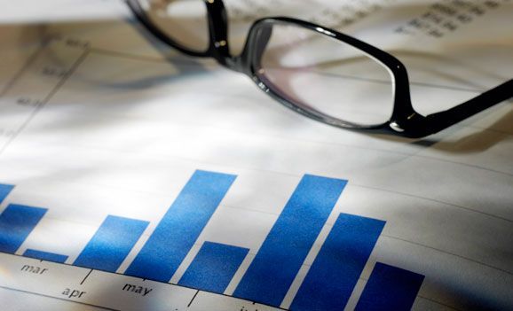 A pair of glasses laying on top of a graph