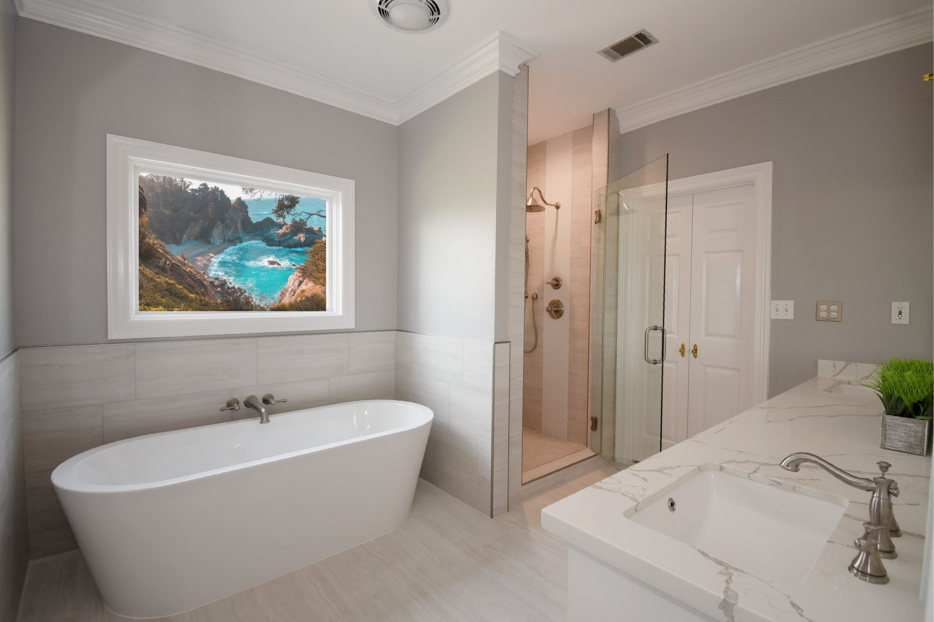 Elegant bathroom with a freestanding tub, shower, marble countertop, and a window with a scenic view.
