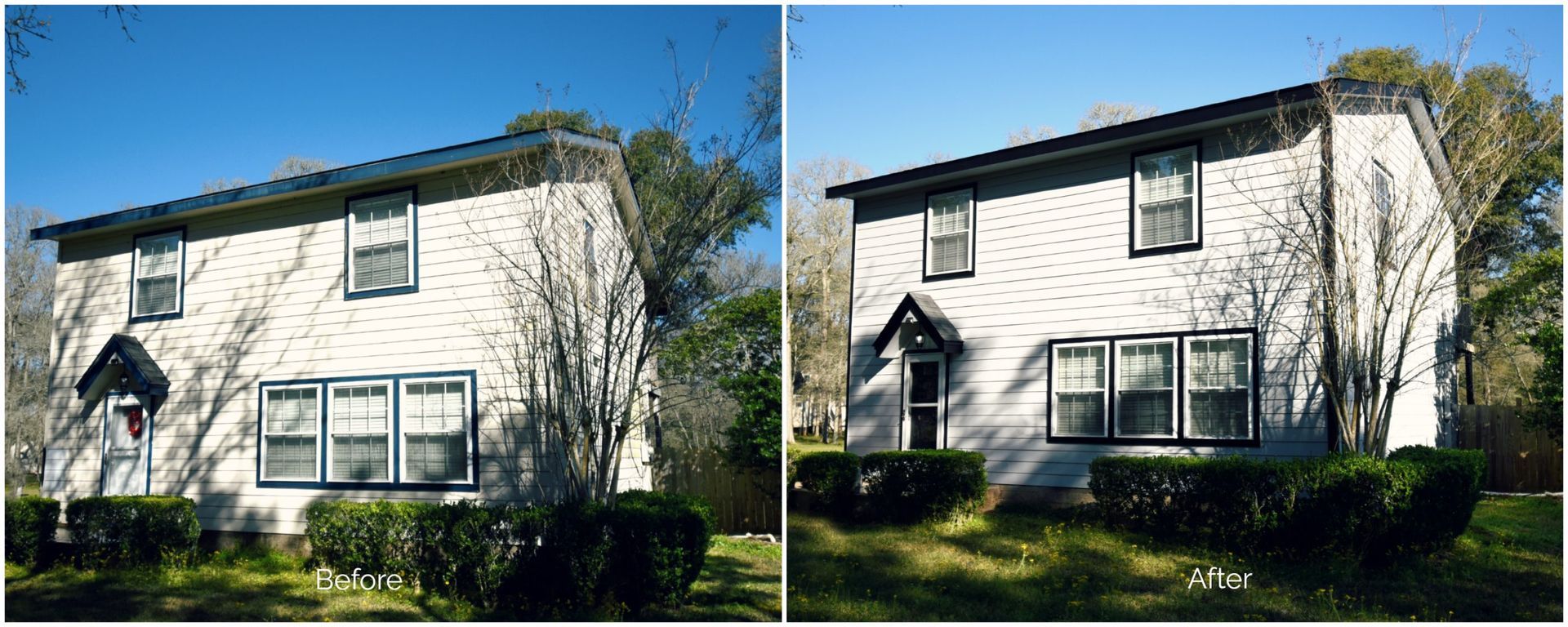 Two-story white house with black trim under a blue sky.
