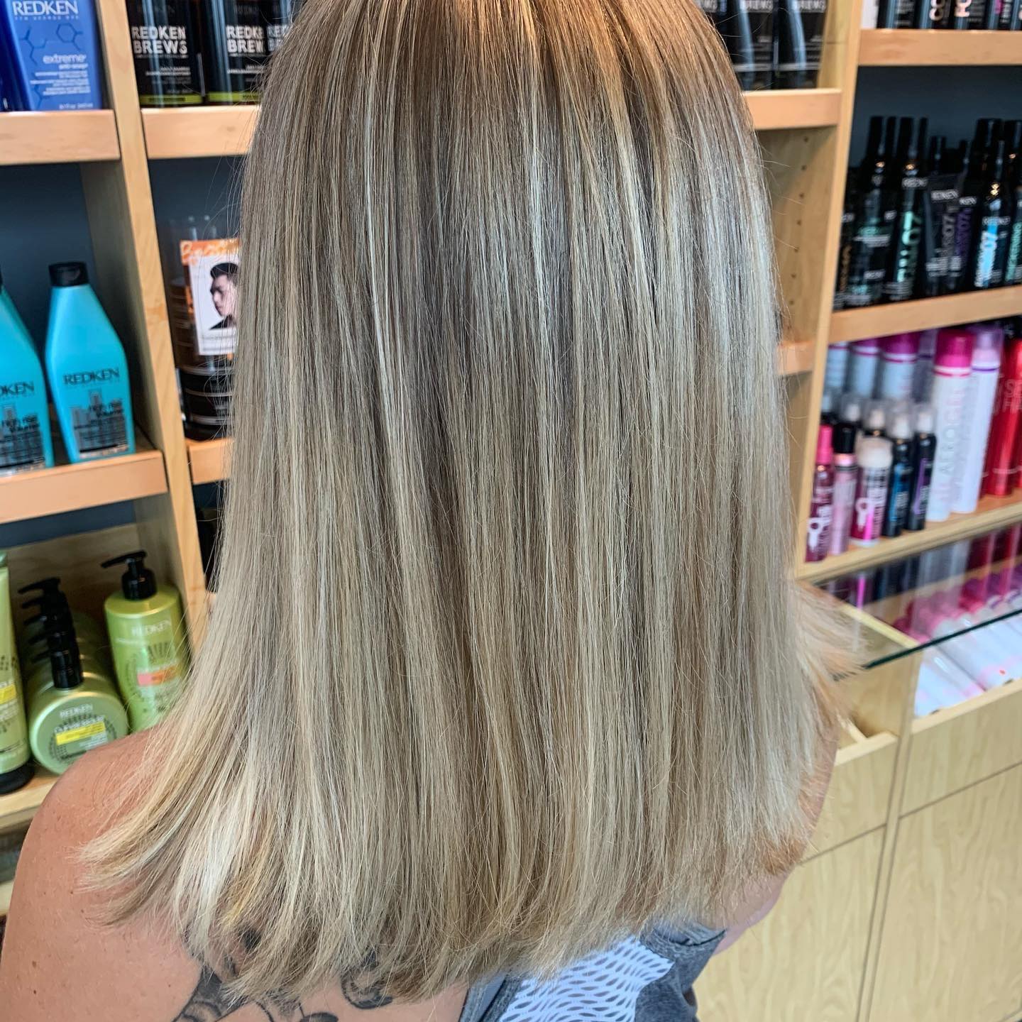 A woman with blonde hair and a tattoo on her back