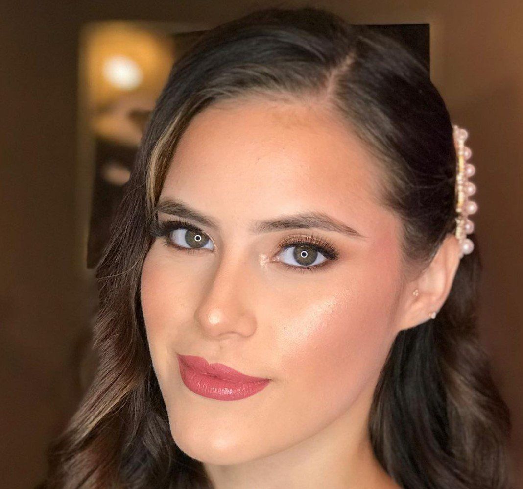 A close up of a woman 's face with a hair clip in her hair.