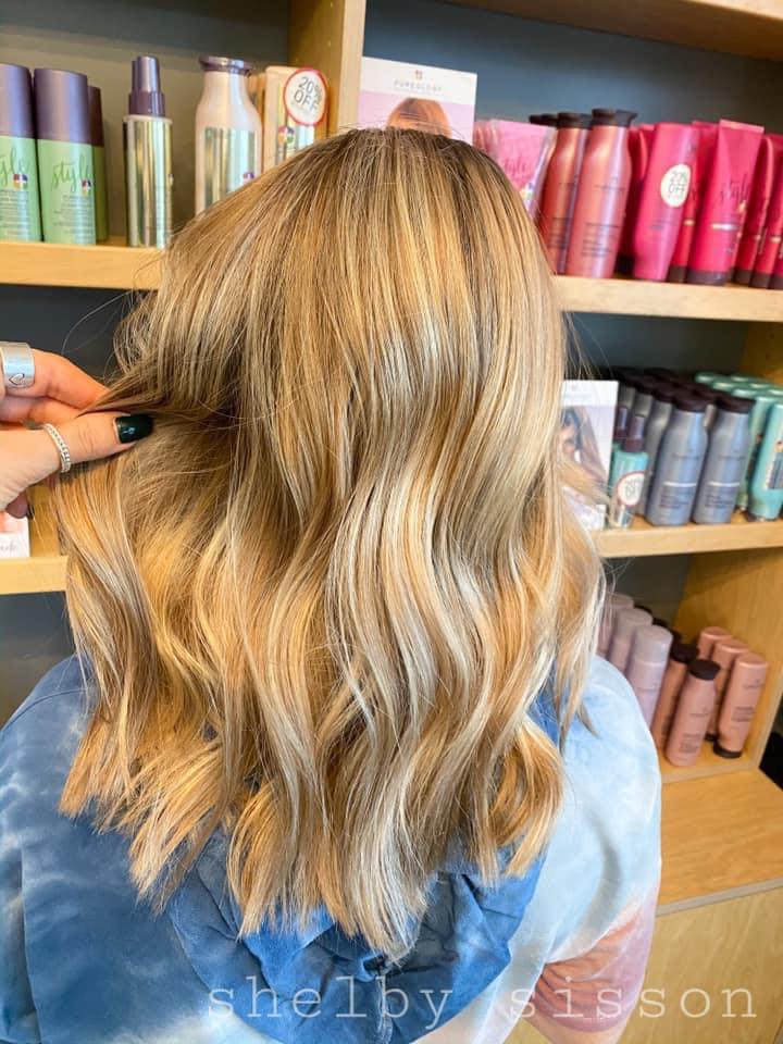 A woman is getting her hair done in a salon.