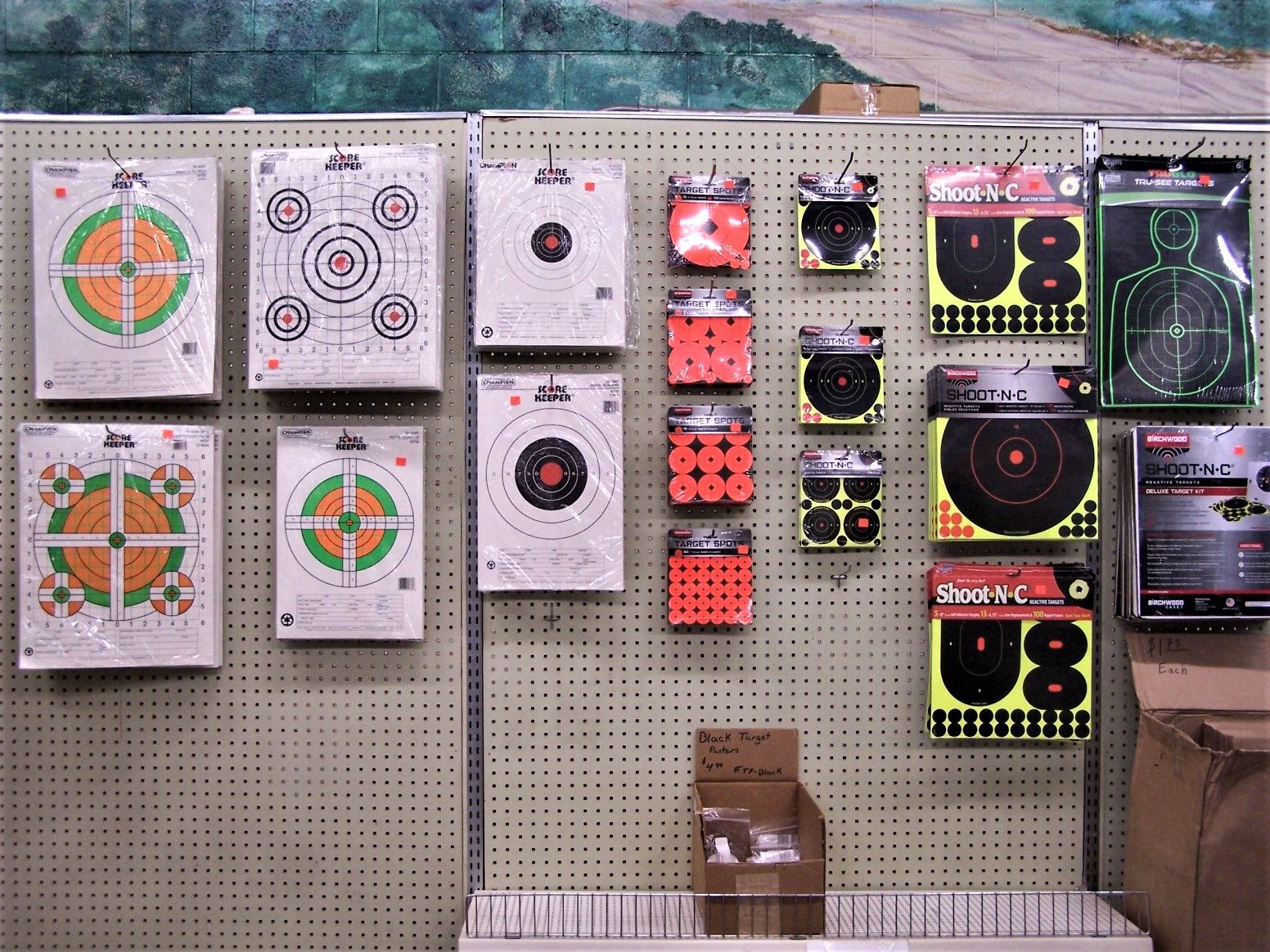 Targets for firearms on display in a retail setting. Various shapes and colors are visible.