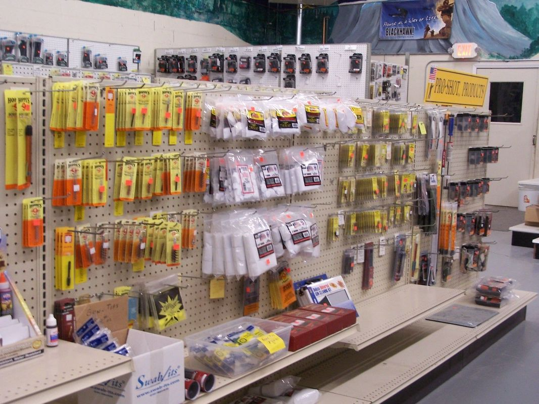 Fishing lures and tackle displayed on shelves in a store.
