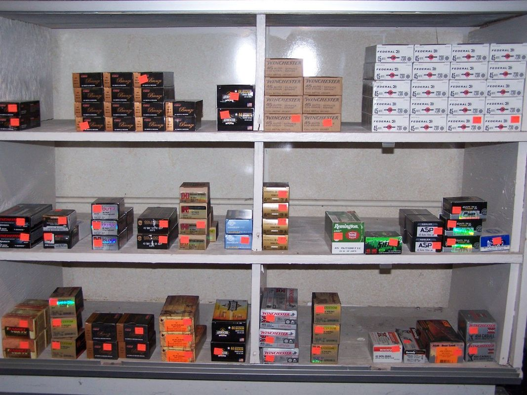 Shelf filled with various packaged electrical components, all with orange price stickers.