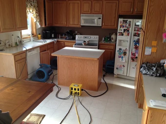 Rhythmic, dark, and light-filled ridges of desert sand stretch diagonally across the frame.