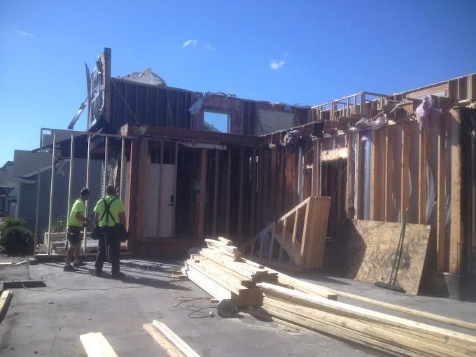 An overhead view of turquoise ocean waves crashing and forming white foam against deep blue water.