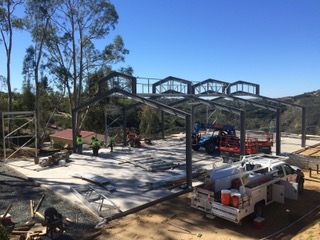 A truck is parked in front of a building under construction.