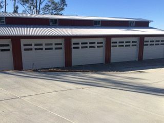 A concrete driveway extending to the garages.