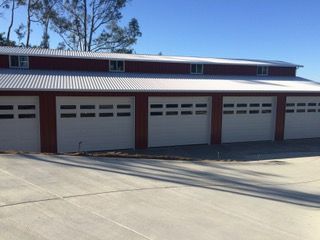 A concrete driveway leading to a row of garages.
