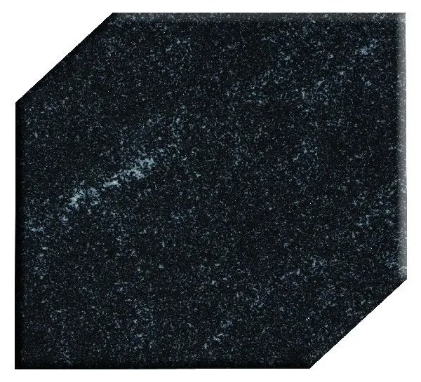 Black speckled octagonal tile or stone sample with beveled corners on a white background