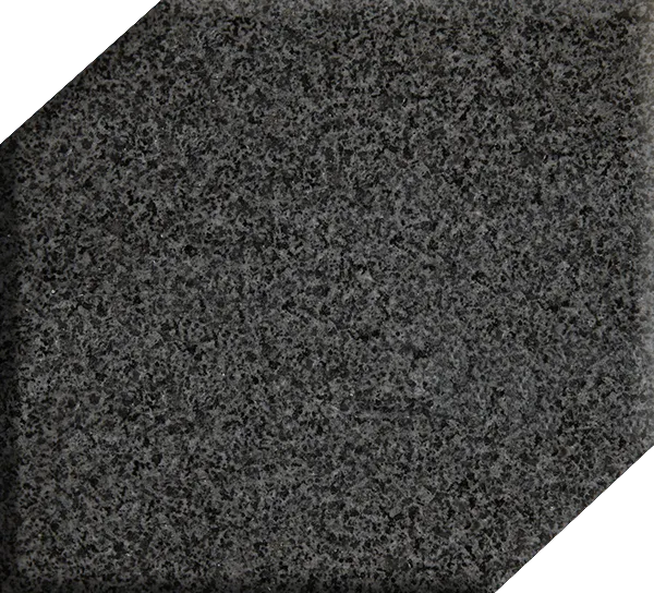 Dark gray speckled textured surface with a white corner visible at the bottom right