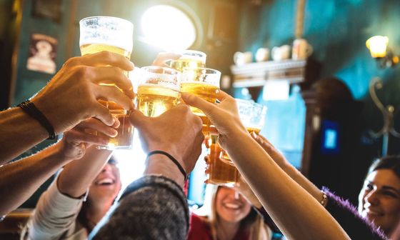 Group of happy friends toasting beer