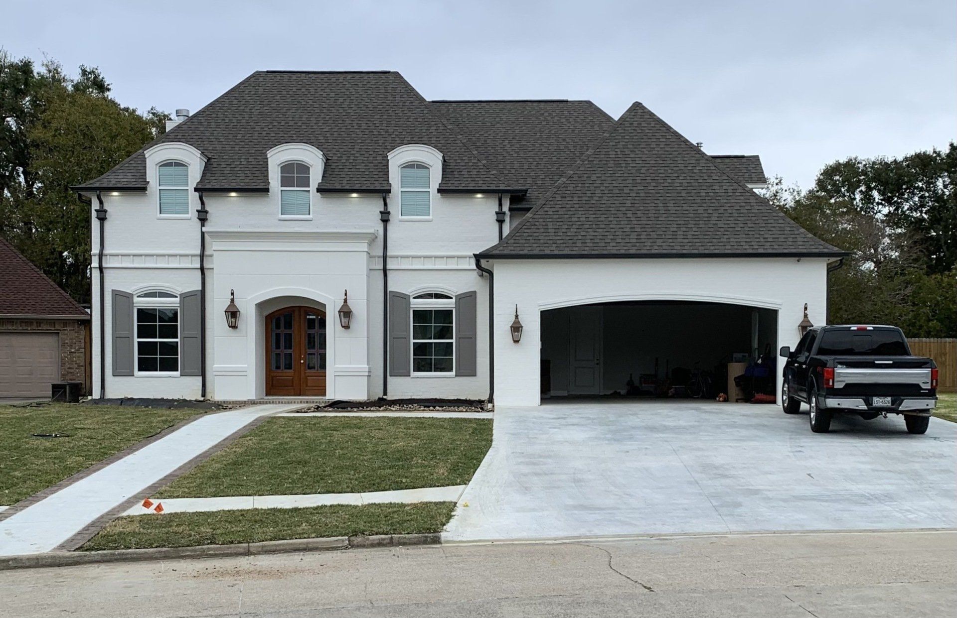 white house with garage open