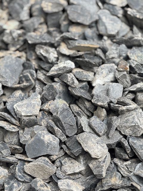 A pile of rocks sitting on top of each other on the ground.