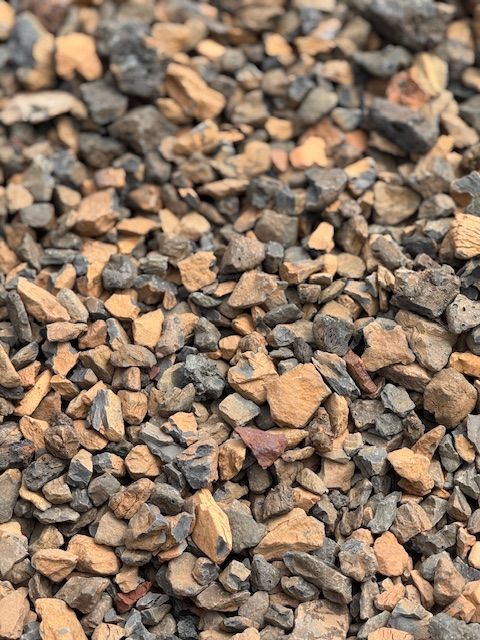 A pile of rocks is sitting on the ground.