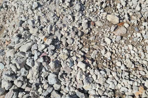 A pile of black mulch is sitting on the ground.