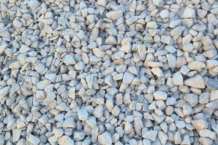 A pile of red mulch is sitting on the ground.