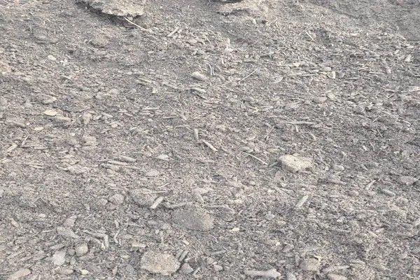 A black and white photo of a pile of dirt and rocks.