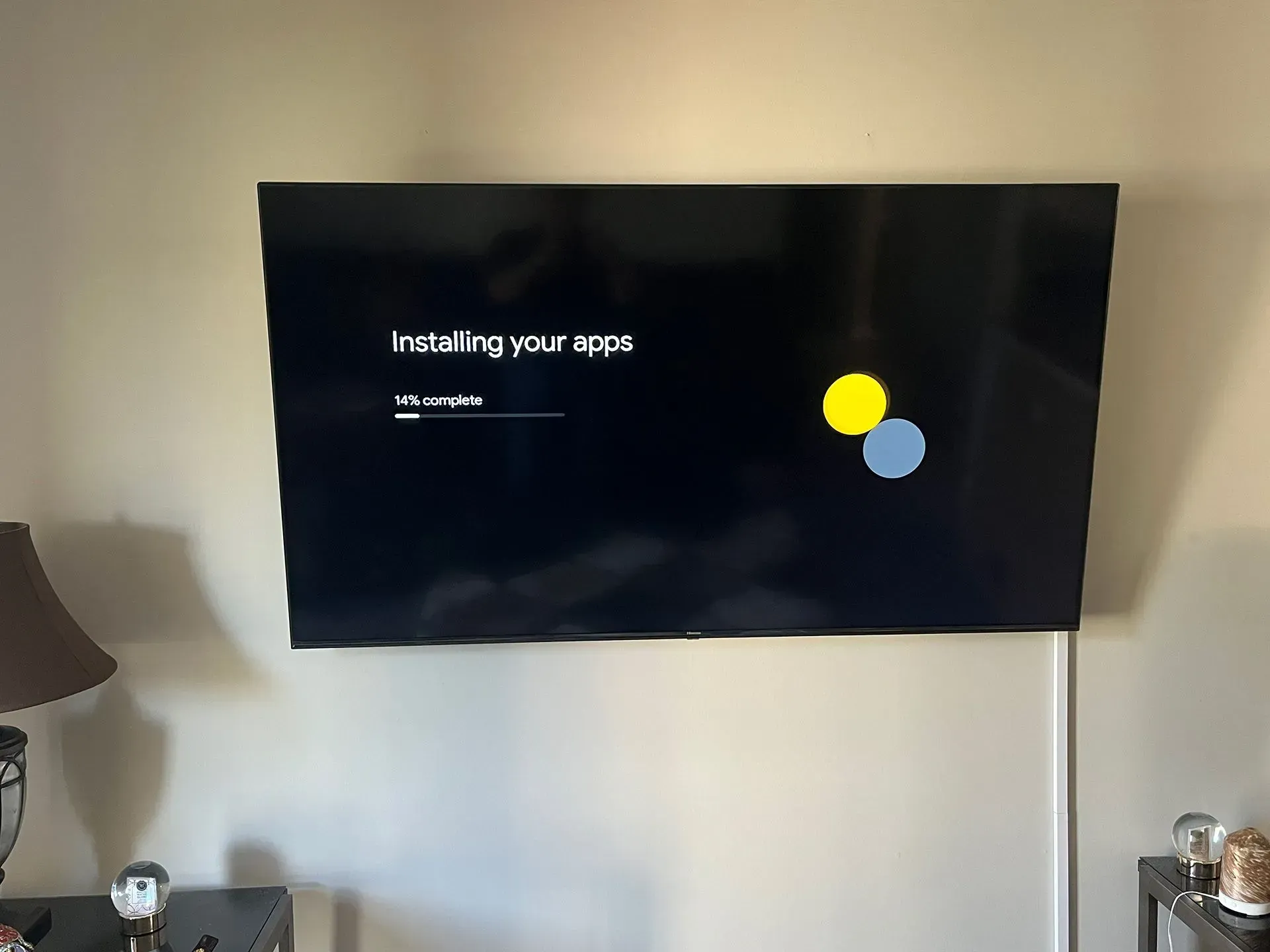 A mounted television screen displays a setup screen with the text 