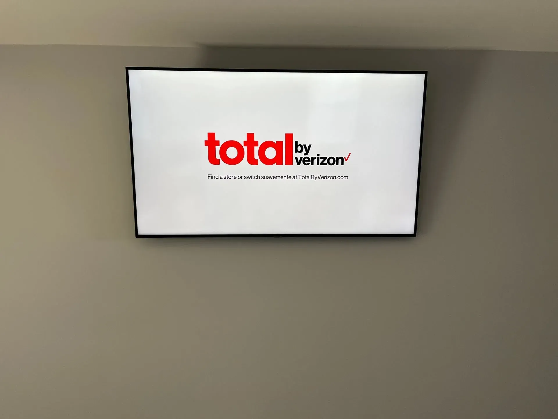 A wall-mounted television screen displaying the red and black 