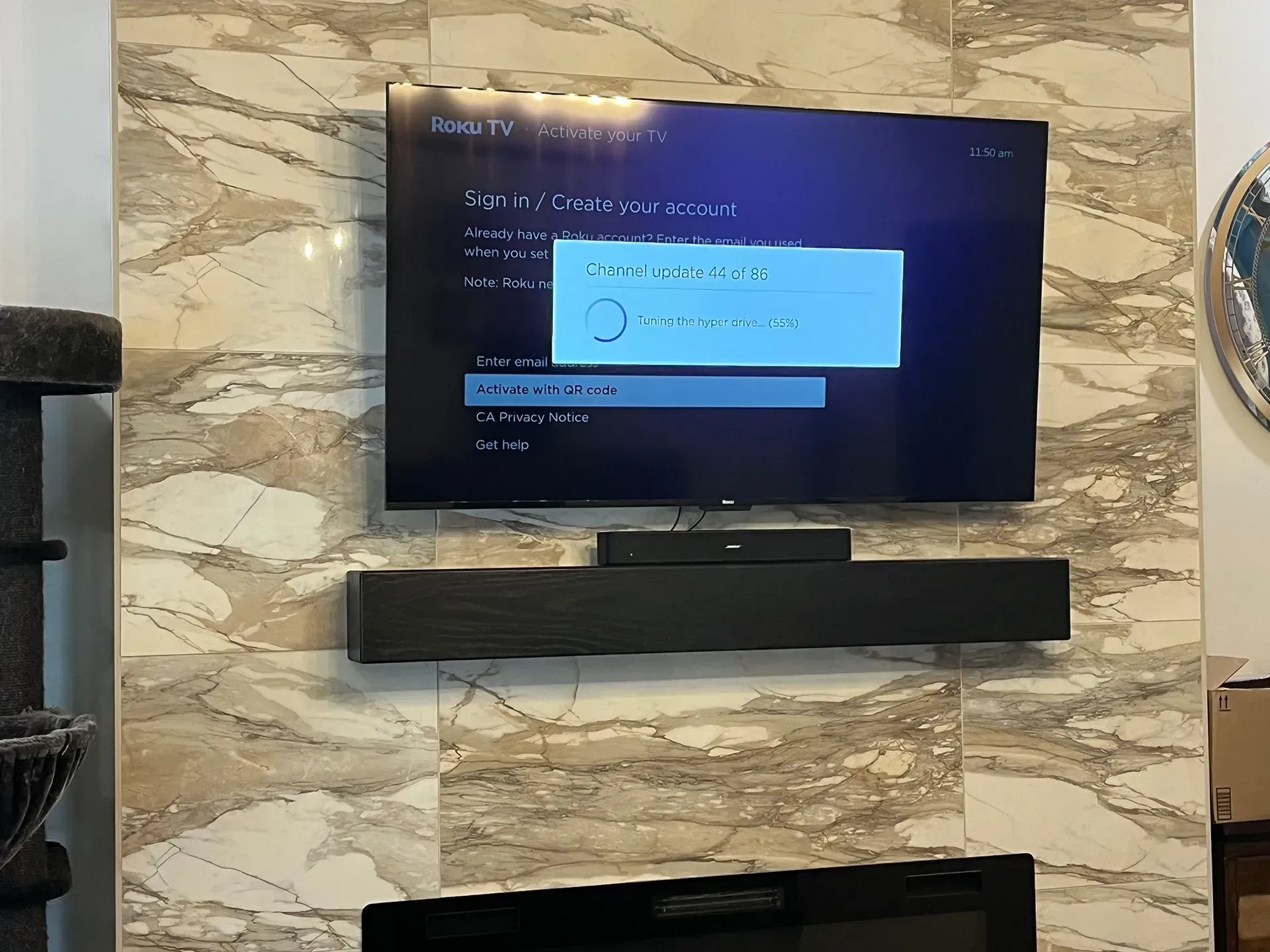 A wall-mounted TV displays a Roku 