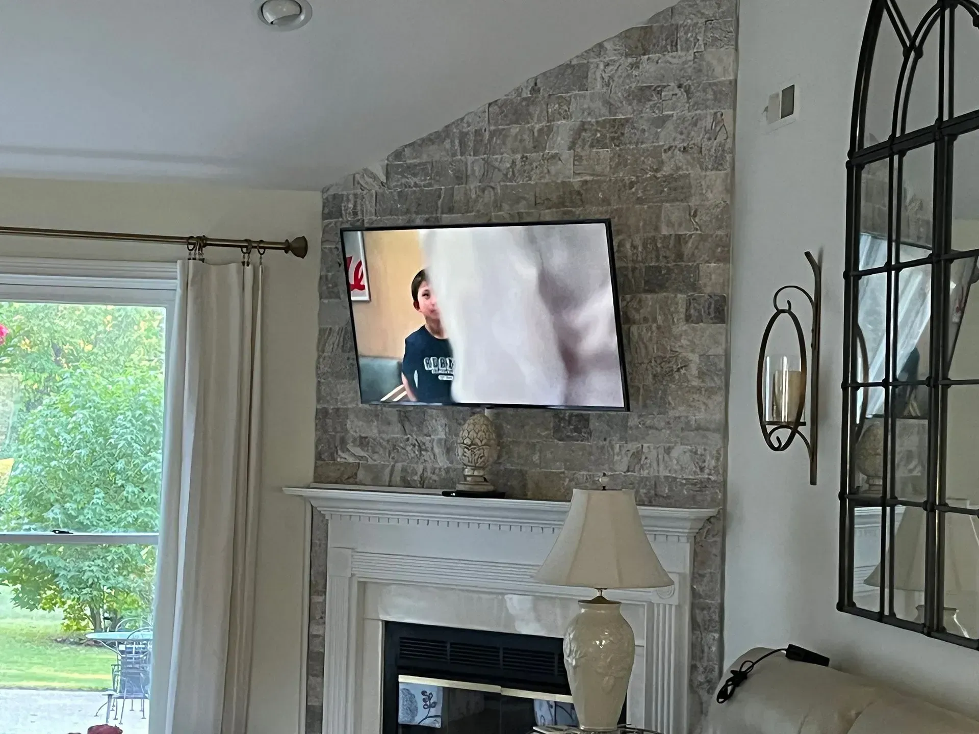 An aerial view of a white, crashing wave against deep turquoise and dark blue ocean water.