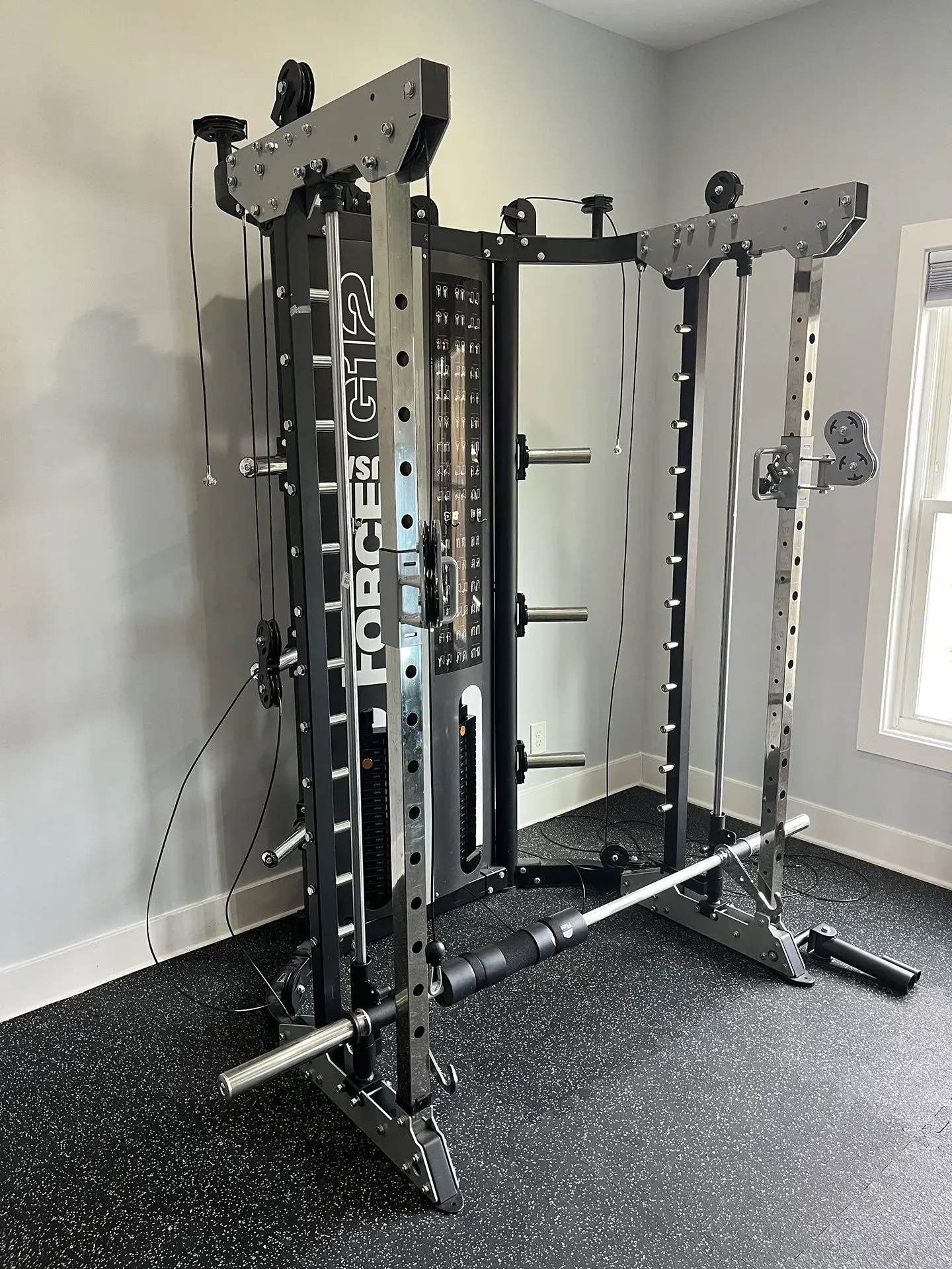 An aerial view of a dark blue river winding through a dense, lush green forest.